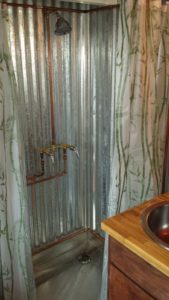 metal shower stall with copper pipes