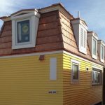 copper mansard roof and yellow siding