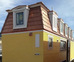 copper mansard roof and yellow siding