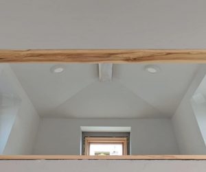 main loft with wood beam across ceiling