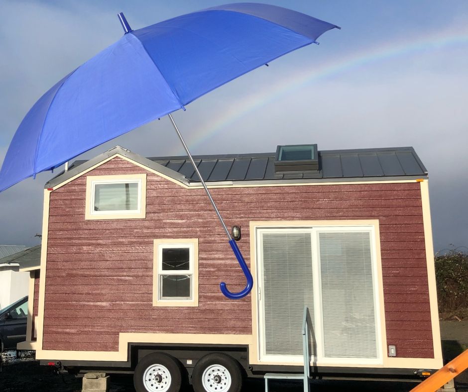 umbrella and rainbow over tiny house